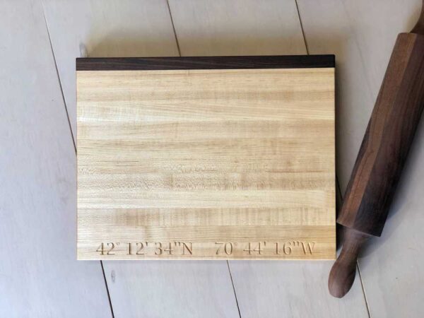 longitude and latitude coordinates engraved on a cutting board