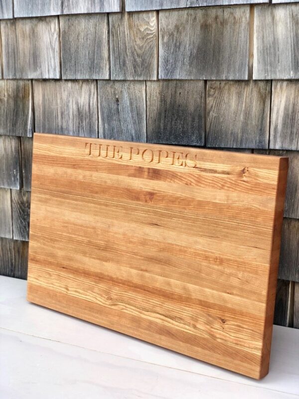 cherry cutting board engraved with a last name